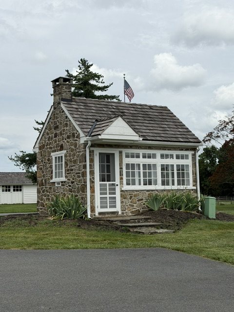 Stone cottage with white windows on the property