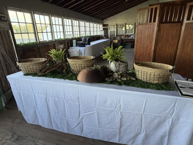 Buffet table styled with baskets and ferns